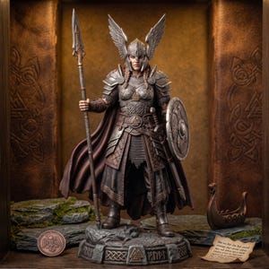 May include: A detailed figurine of a warrior wearing ornate silver armor with a winged helmet, holding a long spear in the right hand and a round shield in the left. The figure stands on a stone base with carved runes, wearing a dark brown cape.