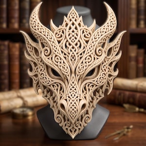 May include: A light beige dragon mask featuring intricate, raised Celtic knotwork patterns across the entire surface. The mask has two prominent curved horns at the top, pointed ear-like structures on the sides, and a detailed snout with nostrils.