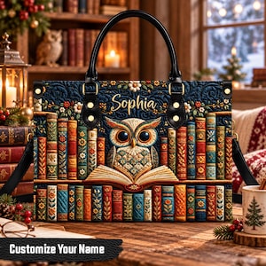 May include: A rectangular handbag featuring a quilted pattern of colorful book spines and a central owl reading an open book. The name Sophia is printed in gold script above the owl. The bag has black leather handles and gold hardware.