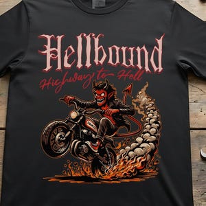 May include: A black short-sleeve t-shirt featuring a graphic print of a red devil riding a motorcycle. The text "Hellbound" appears in a stylized font above the graphic, with "Highway to Hell" written below. The design includes flames and smoke.