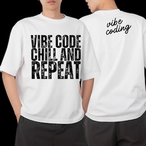 Könnte beinhalten: Weiße T-Shirts mit schwarzem Text. Auf der Vorderseite des Shirts steht "VIBE CODE CHILL AND REPEAT" in fetter, blockartiger Schrift. Auf der Rückseite steht "vibe coding" in Schreibschrift.