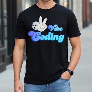 以下が含まれることがあります： 「Vibe Coding」と書かれた黒いTシャツ。グラフィックは、笑顔の顔と「Vibe Coding」という言葉が青と紫で描かれたピースサインの手です。Tシャツはクルーネックです。