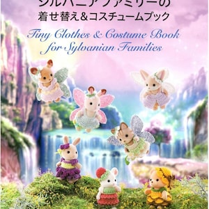 May include: The cover of a book titled "Tiny Clothes & Costume Book for Sylvanian Families" shows Sylvanian Families characters dressed in crocheted fairy costumes. The image features several figures with wings and colourful outfits, set against a waterfall backdrop.