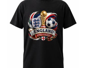 May include: A black short-sleeve t-shirt featuring a graphic print of a gold trophy, a soccer ball, and the England national crest. A banner across the center displays the text ENGLAND WORLD CUP 2026 above a small shield with a red cross.