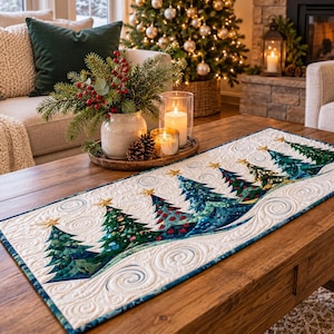 May include: A rectangular quilted table runner featuring a repeating pattern of dark green and blue Christmas trees with gold star toppers. The white fabric background is decorated with intricate swirling machine-stitched patterns throughout.