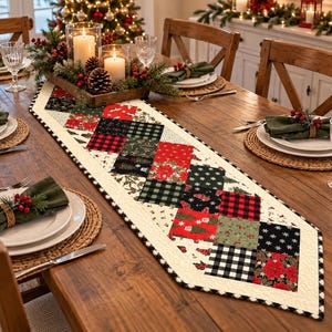 May include: A quilted table runner featuring a patchwork design of red, black, and green squares with holiday-themed patterns including poinsettias, buffalo plaid, and pine trees, finished with a cream-colored border and black trim.