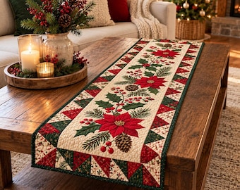 May include: A rectangular quilted table runner featuring a cream-colored center panel with a repeating pattern of red poinsettia flowers, green holly leaves, red berries, and brown pinecones, bordered by a geometric red and green triangular print.