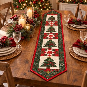 May include: A long rectangular table runner featuring a repeating pattern of green Christmas trees and white star motifs on a cream background, bordered by a red and green floral print. The runner is centred on a wooden dining table.