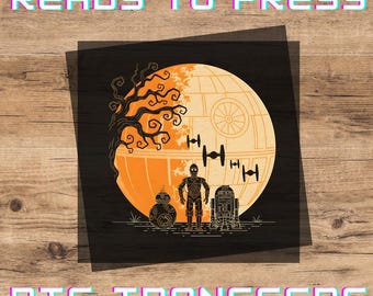 May include: A square DTF transfer sheet featuring a graphic of a large orange moon-like space station, a bare tree, three TIE fighters, and three droids including BB-8, C-3PO, and R2-D2. The text READY TO PRESS and DTF TRANSFERS appears in cyan and magenta.