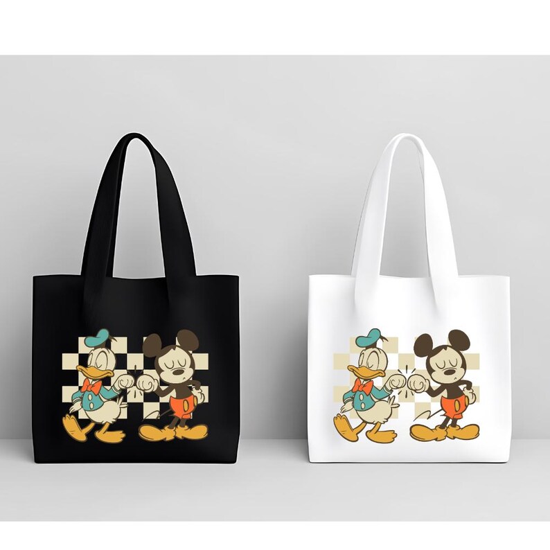 May include: Two tote bags, one black and one white, each featuring a cartoon illustration of Donald Duck and Mickey Mouse bumping fists. The background is a checkered pattern in cream and tan.