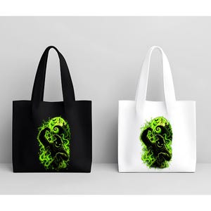 May include: Two tote bags, one black and one white, each featuring a vibrant green graphic print of a shadowy, sack-like character holding dice against a backdrop of a glowing moon, swirling mist, and silhouettes of bats and a crooked hill.