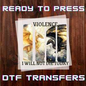 May include: DTF transfers featuring a dragon design. The image includes the text "READY TO PRESS", "VIOLENCE", "I WILL NOT DIE TODAY", and "DTF TRANSFERS". The dragon art has gold and black wings.