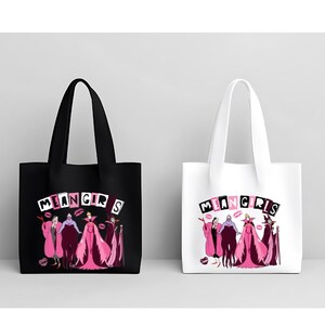 May include: Two tote bags, one black and one white, each displaying the text "MEAN GIRLS" above a cartoon illustration of characters in pink and purple gowns. The bags have long handles.
