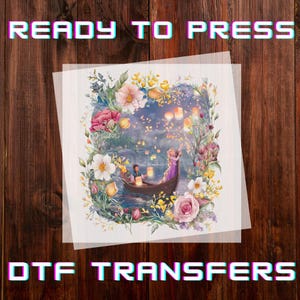 May include: DTF transfer featuring a romantic scene with a couple in a boat surrounded by flowers and lanterns. The image is framed by a floral border and includes the text "READY TO PRESS" and "DTF TRANSFERS" in a colorful font.