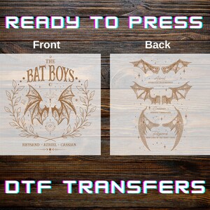 May include: A light-colored DTF transfer featuring a design with the text "THE BAT BOYS" and bat wings. The back of the transfer shows different bat wing designs. The words "READY TO PRESS" and "DTF TRANSFERS" are also visible.