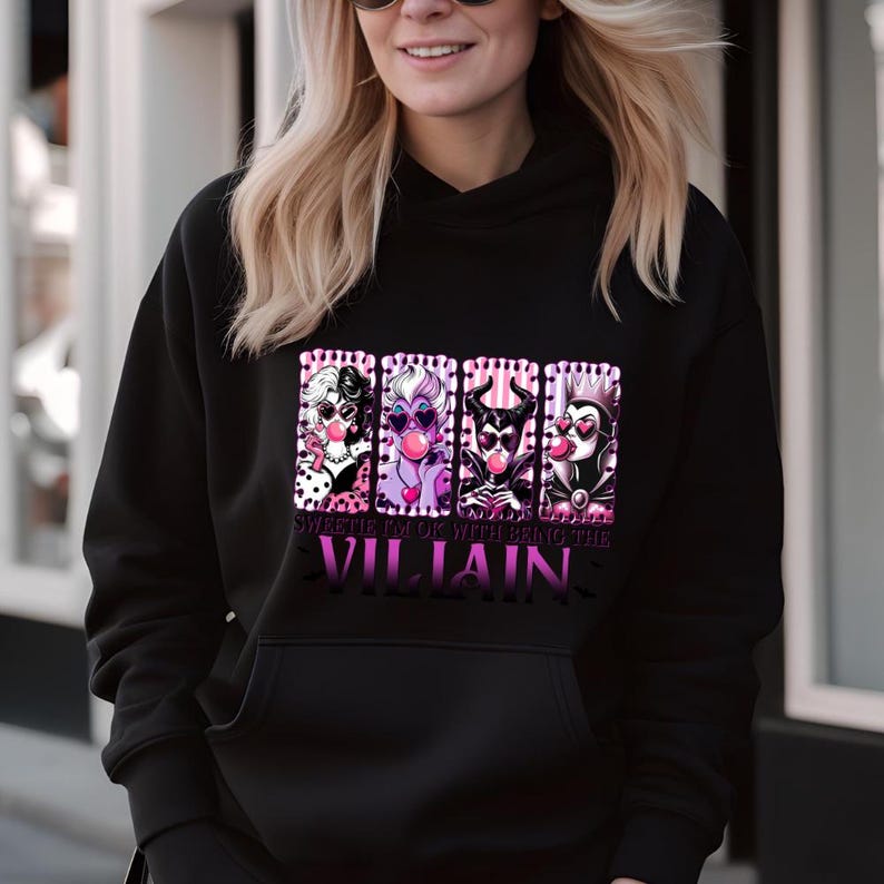 May include: Black hoodie with a graphic featuring four cartoon villains blowing bubblegum bubbles. The graphic includes the text "Sweetie I'm Ok With Being The Villain" in pink and purple.