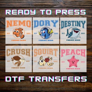 May include: Six DTF transfer designs featuring characters from "Finding Nemo." Each design includes a character name, the text "EST 2003," and "Finding Nemo." The top row features Nemo, Dory, and Destiny. The bottom row features Crush, Squirt, and Peach.