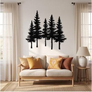 Peut inclure: Une décoration murale en métal noir représentant la silhouette de cinq pins de hauteurs variées. Le design présente des branches et des troncs détaillés, créant une scène de forêt fixée directement sur une surface murale intérieure blanche.