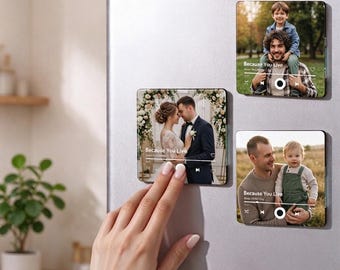 May include: Three square photo magnets featuring custom music player interfaces. Each magnet displays a personal photograph, song title Because You Live, and playback controls. The designs include a wedding scene, a father with a child, and a parent holding a baby.
