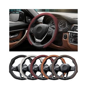 May include: A selection of steering wheel covers in various colors, including black, white, burgundy, tan, and brown. The covers are shown on a car's steering wheel and also displayed separately. The interior of the car is visible in the background.