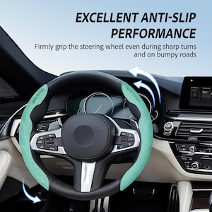 May include: A black steering wheel with a mint green anti-slip cover. The cover has the text "DRIVE IN STYLE" printed on it. The image also includes the text "EXCELLENT ANTI-SLIP PERFORMANCE" and "Firmly grip the steering wheel even during sharp turns and on bumpy roads."
