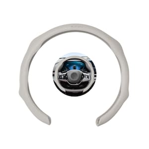 May include: A light gray steering wheel cover with a perforated texture and the text "My ride, my love". The cover is designed to fit around a car's steering wheel. The image also shows a car's steering wheel.