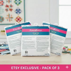 May include: Three Fons & Porter Design Wall packages. Each package has a white background with a teal and pink stripe. The text "Fons & Porter" and "Design Wall" are printed on the front. The packages are hanging from white hooks.
