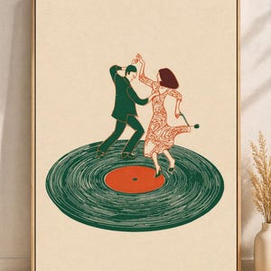 May include: A framed art print showing a couple dancing on a green vinyl record. The dancers are in a retro style, with the man in a green suit and the woman in a patterned dress. The record has an orange centre.