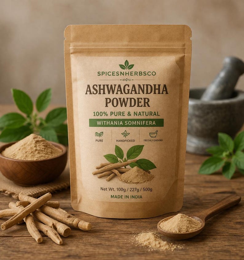 May include: A brown paper bag of Ashwagandha powder with the text "SPICESNHERBSCO" and "ASHWAGANDHA POWDER". The bag also displays the text "100% Pure & Natural" and "WITHANIA SOMNIFERA". A wooden spoon and bowl contain the powder, and some Ashwagandha roots are visible.