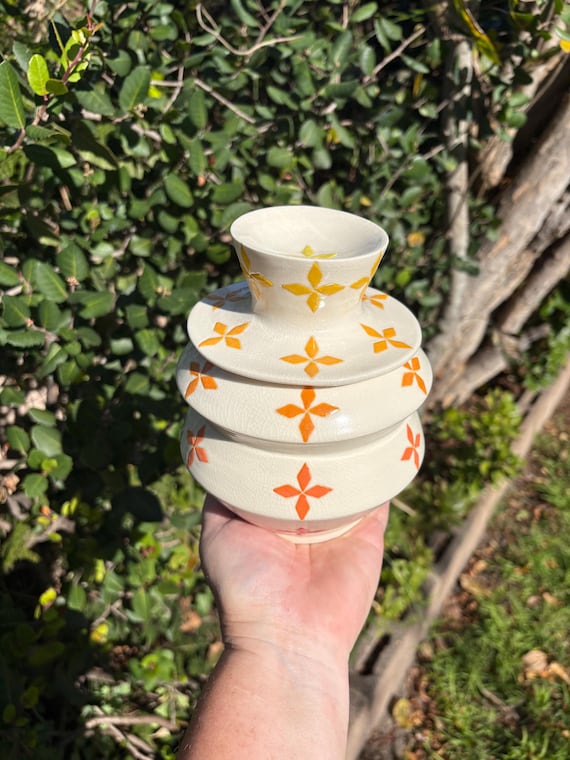 A vivid atomic-orange lidded studio pottery jar — bold enough to anchor a bathroom counter or shelf and functional enough to actually use, 17 favorites backs up the wow factor.
