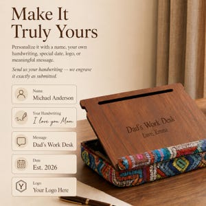 May include: A wooden desk organizer featuring a dark brown wood top engraved with the text 'Dad's Work Desk' and 'Love, Emma'. The base is wrapped in a colorful, multi-patterned fabric with geometric embroidery in blue, red, and yellow tones.