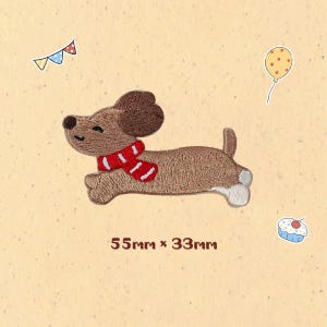 May include: Embroidered patch of a brown dachshund dog wearing a red and white scarf, running. The patch measures 5.5cm x 3.3cm. A yellow balloon, a cupcake, and a banner are in the background.