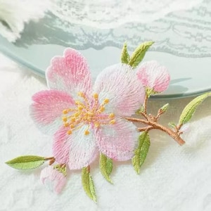 May include: A white ceramic mug with a black handle and the text "But First, Coffee" in a bold, black font. The mug is likely 310-425 ml in size, ideal for a morning beverage.