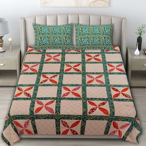 May include: A bedspread and two matching pillow shams featuring a grid pattern. The design consists of beige squares with a subtle diamond stitch, alternating with dark teal bands decorated with red, four-petaled floral motifs and yellow dots.
