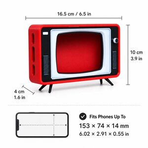May include: A red and black retro-style television phone stand measuring 6.5 inches wide, 3.9 inches high, and 1.6 inches deep. It features a white screen frame and fits phones up to 6.02 by 2.91 by 0.55 inches. The stand has four small black legs.