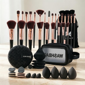 May include: A complete makeup brush set with black handles, rose gold ferrules, and dark brown bristles. The set includes various brush sizes, a black bag, sponges, and a black cosmetic bag with the text "WASHBAG".