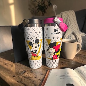 May include: A trio of ceramic mugs with a speckled, matte finish in cream, light grey, and dark grey. Each mug features a minimalist design and a rounded handle.