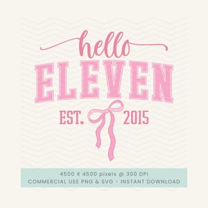 May include: A pink graphic design with the words "hello ELEVEN" in a script and block font. Below the text is "EST. 2015" and a pink bow. The background is a light cream color with a subtle chevron pattern.