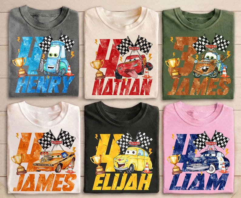 May include: Six colorful t-shirts featuring race car designs with names and the number 4. Each shirt has a different car graphic, checkered flags, a trophy, and a name: Henry, Nathan, James, Elijah, and Liam.