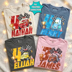 May include: Four Comfort Colors t-shirts in cream, blue, charcoal, and pink. Each shirt features a cartoon race car design with a trophy, checkered flags, and a name. The text "All Pokemon Characters" is in a teal bubble.