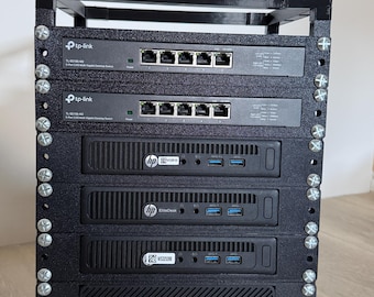 May include: A black 3D-printed rack housing two TP-Link TL-SG105-M2 5-port 2.5G multi-gigabit desktop switches and four HP EliteDesk mini PCs. The components are stacked vertically and secured with silver metal screws in the frame.