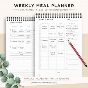 May include: Two spiral-bound weekly meal planners with a white background. The top text reads "WEEKLY MEAL PLANNER". The planners have sections for breakfast, lunch, and dinner, with a grocery list on the right. A red pencil rests on the right planner.