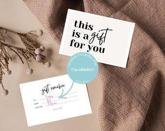 May include: Two white gift cards with black text on a neutral background. One card reads "this is a gift for you." The other is a gift voucher with fields for "To", "From", and "Valid For". A sprig of dried foliage is in the upper left.