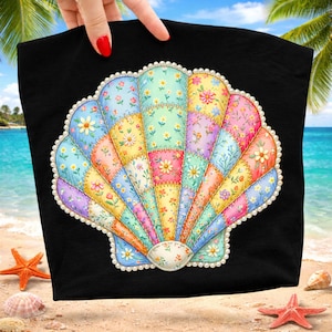 May include: Black tote bag featuring a colorful seashell design. The seashell is made of patchwork fabric with floral patterns in various colors, including yellow, pink, blue, and purple. The edges of the seashell are outlined with white pearls.