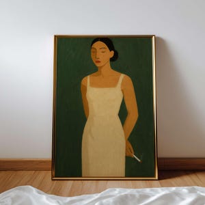 May include: A framed art print featuring a woman in a cream-colored dress against a dark green background. The woman has dark hair and is holding a lit cigarette. The artwork is in a gold frame and is displayed on a wall.