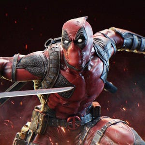 May include: A detailed action figure of Deadpool in a dynamic pose, clad in a red and black suit. The figure is holding a sword, with a detailed belt and harness. The background is a dark red with sparks.