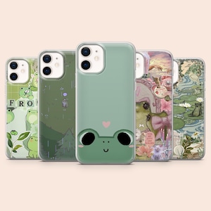 May include: Five smartphone cases arranged in a row, each featuring distinct designs. The cases display various green-toned illustrations including cartoon frogs, a rainy forest scene, a minimalist frog face, a collage, and a pond landscape.