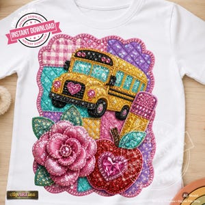May include: A white t-shirt featuring a sequined graphic design of a yellow school bus, a pink flower, a red apple with a heart, and a pencil. The background of the design consists of a quilted-style patchwork pattern in pink, purple, and teal.