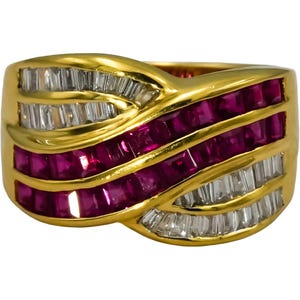 May include: A gold ring with a wave design, featuring alternating rows of rectangular-cut rubies and baguette-cut diamonds. The ring has a polished gold band and a vibrant appearance.