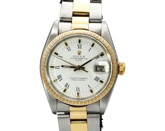May include: A Rolex Oyster Perpetual Date watch with a white dial, gold bezel, and gold and silver-tone stainless steel band. The watch face features Roman numeral hour markers and a date display at the 3 o'clock position.